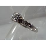 A lady's hallmarked 9ct white gold five diamond dress ring, centre diamond approx 20 points,