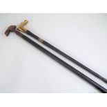 Walking sticks - a brass handled walking stick with silver hallmarked mount London assay and a