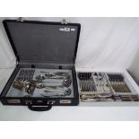 A cutlery set by Willhiem displayed in a faux leather case.