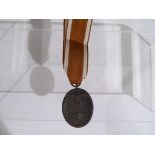 A Deutsches Schutzwall-Ehrenzeichen (Westwall) medal, with ribbon.