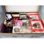 A jewellery box containing a quantity of vintage costume jewellery to include paired earrings,