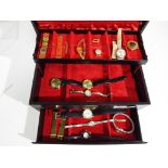A concertina style jewellery box containing eleven wristwatches and spares to include Lorus,