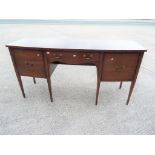 A mahogany serpentine sideboard with stringing,
