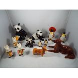A quantity of ceramic animal figurines to include Beswick Corgi, Beswick Penguins, Goebel Panda,
