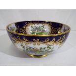 A George Jones and Sons Crescent bowl with panels depicting exotic birds,
