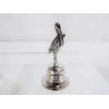 A silver stork on bell, stamped 925, approx 4cm (h) Est £20 - £40.