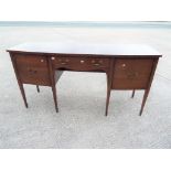 A mahogany serpentine sideboard with str