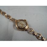 9ct gold - a Regency 17 jewel automatic Swiss made movement with 9ct gold case and strap,