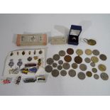 A lot to include small quantity of coins, £2 coins, pin badges, transport tickets and similar.