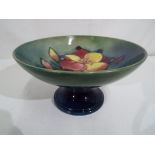 Moorcroft - a Moorcroft pottery ceramic tazza, decorated with freesia on a green ground,