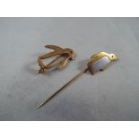 A 9ct gold hallmarked tie pin in the form of a penguin and a 9ct gold brooch in the form of