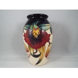 Moorcroft - a Moorcroft pottery vase in Anna Lily pattern, approximately 13 cm [h], Est £80 - £120.