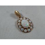 A lady's 9ct gold pendant set with a cluster of opal Est £20 - £40