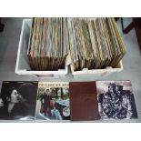 Two boxes of 33 rpm vinyl records to include John Lennon, Roy Orbison, Carpenters,