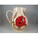 Moorcroft - a Moorcroft pottery jug in Harvest Poppy pattern, approximately 15 cm [h],