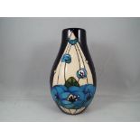 Moorcroft - a Moorcroft pottery vase in Rennie Rose pattern on Blue ground,