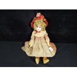 Victorian doll - an antique bisque headed dressed jointed doll with sleeping glass eyes,