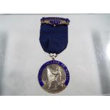A silver hallmarked and enamelled medal Birmingham assay, dated April 1952,