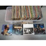 A large quantity of 33 RPM vinyl records to include Meat Loaf, Ultravox, Elton John,