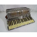 A vintage piano accordion by Fontanella, contained in a case, Est £70 - £100.