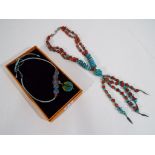 An unusual natural stone and white metal beaded multi-stranded necklace,