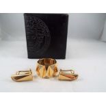 Versace - an 18ct gold ring,