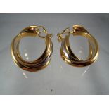 A pair of hooped earrings marked 18kt, approx weight 18.