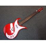 Danelectro - an electric six string solid guitar finished in cherry red,