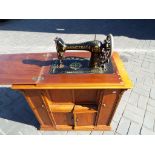 Singer sewing machine - a late 19th century Victorian oak cased treadle Singer sewing machine