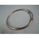A 9kt white and yellow gold bangle safety clasp, approx weight 4.