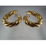 A pair of heavy 18ct gold earrings with flick back clasps, stamped 750 to the clasp and earring,