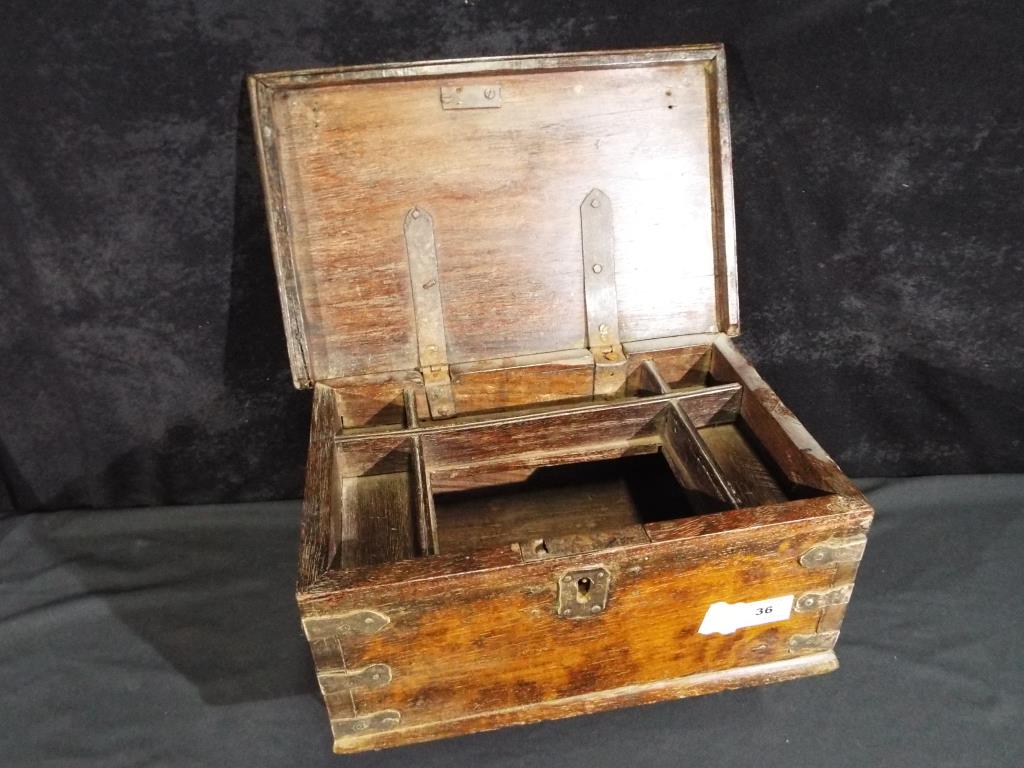 A hinge-lidded oak chest with fitted interior, approx 16 cm x 34 cm x 21.