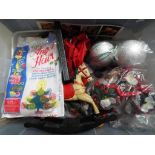 A box containing a collection of Christmas items to include plastic flowers, tree decorations,