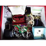 A box of unsorted costume jewellery