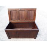 A good quality oak hinged lid linen chest, approximate height 54 cm x 54 cm x 109 cm.
