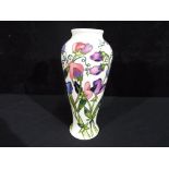 Moorcroft - a Moorcroft pottery vase in Sweet Pea pattern, approximately 21 cm [h], Est £80 - £120.