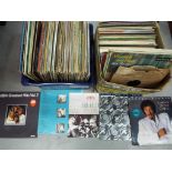 Two boxes of 33 rpm vinyl records to include ABBA, Dire Straits, Van Halen,