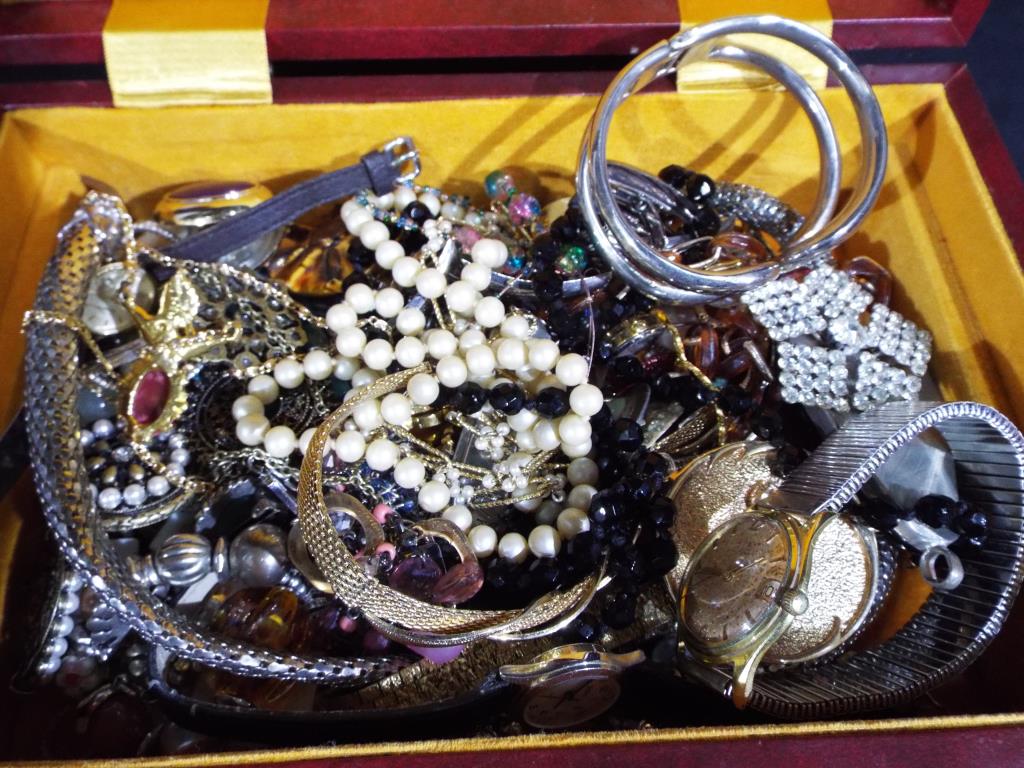 A jewellery box containing a good mixed lot of costume jewellery to include white metal chain