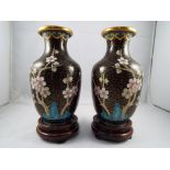 A small pair of Chinese cloisonne vases ruyi border to the neck, decorated with prunus,