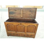 An oak linen chest with twin drawers below,