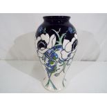 Moorcroft - a large Moorcroft pottery trial vase, decorated in white splendour pattern,