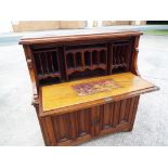 An unusual mahogany bureau with carved decoration,