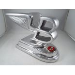 Chrome Bentley wings on base, Est £40 - £60.