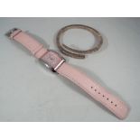 A Nina Ricci wristwatch with Swiss movement, leather strap marked Nina Ricci,