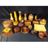 A quantity of treen to include trinket boxes, vases, lidded jars and similar.