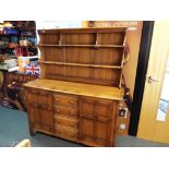 Ercol - a mid-elm Ercol dresser two door and four drawers with internal cutlery drawer,
