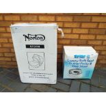 A boxed Norton Storm child's car seat and a boxed Tippi Toes luxury soft seat training potty and