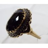 A 9 carat gold ring with black stone and diamonds, size of the ring is R and the weight is 5.05 g.