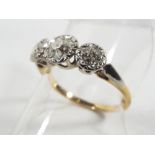 An 18 carat gold and platinum triple stone diamond ring, approximately 60 - 70 points of diamond,