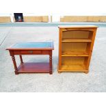 A small free standing pine bookcase with two shelves,